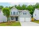 Charming two-story home with a well-manicured lawn, attached two car garage and stone accents at 174 Bloomfield Cir, Canton, GA 30114