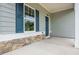 Close up of a covered front porch with stone accents and painted siding at 174 Bloomfield Cir, Canton, GA 30114