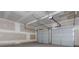 Spacious garage with overhead door and opener; perfect for multiple vehicles and storage at 174 Bloomfield Cir, Canton, GA 30114