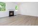 Bright living room with a fireplace and light wood flooring at 174 Bloomfield Cir, Canton, GA 30114