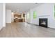 Open-concept living room with fireplace and view of the kitchen at 174 Bloomfield Cir, Canton, GA 30114