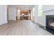 Spacious living room and kitchen with wood floors and a fireplace at 174 Bloomfield Cir, Canton, GA 30114