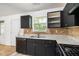 Kitchen with stainless steel sink, dishwasher, ample countertop space, and a view of the backyard at 3694 Arrowhead Pl, Douglasville, GA 30135