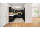Kitchen featuring tiled floors, ample cabinet space, black appliances, and a functional design at 3694 Arrowhead Pl, Douglasville, GA 30135