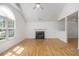 Bright living room with fireplace, hardwood floors, and large windows at 3694 Arrowhead Pl, Douglasville, GA 30135
