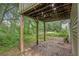 Covered patio area with columns and a debris covered concrete slab at 3694 Arrowhead Pl, Douglasville, GA 30135