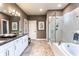 Spacious bathroom with double vanity, soaking tub, glass shower, and tile flooring at 5121 Hillside Haven Drive, Powder Springs, GA 30127