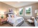 Cozy bedroom with two windows, a decorative bed, and stylish bedside tables at 5121 Hillside Haven Drive, Powder Springs, GA 30127