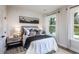 Neutral bedroom with white bedding and a mountain landscape art piece above the headboard at 5121 Hillside Haven Drive, Powder Springs, GA 30127