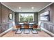 Elegant dining room featuring stylish paneling, modern lighting, and a large window with a scenic view at 5121 Hillside Haven Drive, Powder Springs, GA 30127