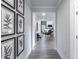 Inviting home hallway featuring wood-look flooring, neutral paint, decorative wall art, and an open view to the living area at 5121 Hillside Haven Drive, Powder Springs, GA 30127