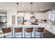 Modern kitchen featuring a large island with seating, pendant lighting, and sleek countertops at 5121 Hillside Haven Drive, Powder Springs, GA 30127
