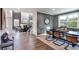 Open-concept living space with a dining area, living room with fireplace, and hardwood floors at 5121 Hillside Haven Drive, Powder Springs, GA 30127