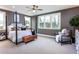 Spacious main bedroom with natural light, ceiling fan, and decorative seating area at 5121 Hillside Haven Drive, Powder Springs, GA 30127
