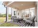 Covered outdoor patio features a seating area with a table and outdoor rug at 5121 Hillside Haven Drive, Powder Springs, GA 30127