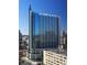 A stunning high rise featuring blue tinted windows against a clear blue sky in a vibrant city setting at 860 Peachtree Ne St # 1712, Atlanta, GA 30308