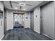 This is a modern hallway with carpet floors, grey walls, an exit sign, and access to elevators at 860 Peachtree Ne St # 1712, Atlanta, GA 30308