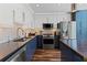 Well-equipped kitchen with stainless steel appliances, marble backsplash, and a functional layout for cooking at 860 Peachtree Ne St # 1712, Atlanta, GA 30308