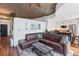 Open-concept living room with a leather sofa adjacent to the kitchen at 860 Peachtree Ne St # 1712, Atlanta, GA 30308