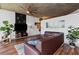 Cozy living room with leather sofa, industrial ceiling fan, and plants at 860 Peachtree Ne St # 1712, Atlanta, GA 30308