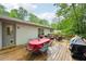 Wooden backyard deck featuring outdoor dining table, seating area, and grill at 1118 Creekdale Dr, Clarkston, GA 30021