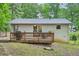Back of house with a wood deck, outdoor furniture, and a stainless gas grill at 1118 Creekdale Dr, Clarkston, GA 30021