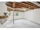 Spacious unfinished basement with painted concrete floor and exposed ceiling beams at 1118 Creekdale Dr, Clarkston, GA 30021
