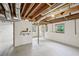 Basement view showcasing the large open space with windows and exposed beams at 1118 Creekdale Dr, Clarkston, GA 30021