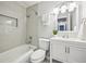 Bright bathroom featuring a white vanity, tiled shower and tub, plus modern fixtures at 1118 Creekdale Dr, Clarkston, GA 30021