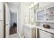 Bathroom with modern vanity, storage, updated mirror and light fixtures at 1118 Creekdale Dr, Clarkston, GA 30021