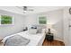 Cozy bedroom featuring a large bed with plush pillows, a ceiling fan, and natural light at 1118 Creekdale Dr, Clarkston, GA 30021