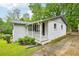 Charming exterior view of white painted home with inviting front porch and landscaped yard at 1118 Creekdale Dr, Clarkston, GA 30021