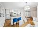 Modern kitchen featuring stainless steel appliances, a marble island, and hardwood floors, adjacent to the dining area at 1118 Creekdale Dr, Clarkston, GA 30021