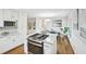 Modern kitchen boasts a large island with a gas range and marble countertops, open to the dining area at 1118 Creekdale Dr, Clarkston, GA 30021