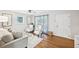 Bright living room featuring wood floors, plush rug, stylish furniture, and front door access at 1118 Creekdale Dr, Clarkston, GA 30021
