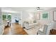 Open-concept living room with hardwood floors, elegant furniture, and seamless flow to dining area at 1118 Creekdale Dr, Clarkston, GA 30021