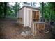 Functional outdoor shed with ramp access and exterior shelving, providing ample storage solutions at 1118 Creekdale Dr, Clarkston, GA 30021