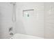 Shower and tub combination with modern tile backsplash and shower head at 1118 Creekdale Dr, Clarkston, GA 30021