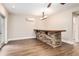 Basement bar featuring a stone accent wall and a unique chandelier at 4910 Bucknell Trce, Cumming, GA 30028