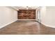 Spacious basement with light walls, a wood accent wall, and wide plank wood flooring at 4910 Bucknell Trce, Cumming, GA 30028