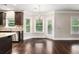Bright dining area with hardwood floors, decorative lighting, and large windows for natural light at 4910 Bucknell Trce, Cumming, GA 30028