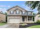 Charming two-story brick home featuring a covered front porch and well-manicured lawn at 4910 Bucknell Trce, Cumming, GA 30028