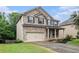 Beautiful two-story home with a brick exterior, black shutters, and a manicured lawn at 4910 Bucknell Trce, Cumming, GA 30028