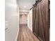 Hallway featuring wood floors and a sliding wood door to an adjacent room at 4910 Bucknell Trce, Cumming, GA 30028