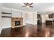 Open-concept living room with stone fireplace flowing into the modern kitchen at 4910 Bucknell Trce, Cumming, GA 30028
