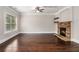 Inviting living room boasts hardwood floors, stone fireplace, and recessed lighting at 4910 Bucknell Trce, Cumming, GA 30028