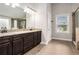 Modern main bathroom with double vanity, granite countertop and tiled shower at 4910 Bucknell Trce, Cumming, GA 30028