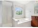 A bright bathroom featuring a large soaking tub, walk-in shower and window view at 7280 Wright Dr, Atlanta, GA 30349