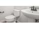Close up of powder room featuring pedestal sink and toilet at 7280 Wright Dr, Atlanta, GA 30349