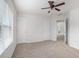 A carpeted bedroom with a ceiling fan, two closets and two white doors at 7280 Wright Dr, Atlanta, GA 30349